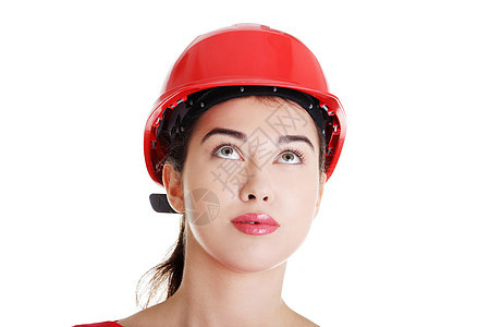 佩戴头盔的自信女工抬头看建筑师人士企业家女性公司帽子安全商务承包商工作图片