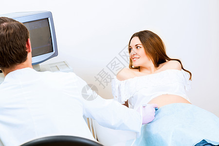 接受医生诊治的怀孕妇女病人生育力待产微笑顾问卫生夫妻女性检查测量图片