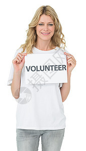 微笑的年轻女性志愿者持有标牌的肖像服务社区社会道德志愿女士文档幸福头发浅色图片