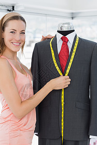 女时装设计员测量假体服装卷尺礼服职业工作女性手工办公室剪裁设计师微笑图片