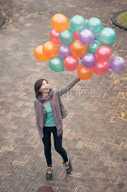 青年妇女玩耍和持有气球快乐女性魅力乐趣微笑女士图片