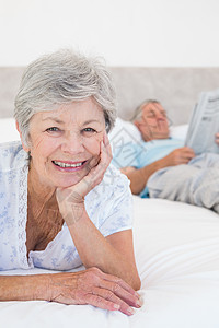 微笑的老年女人和男人在床上图片