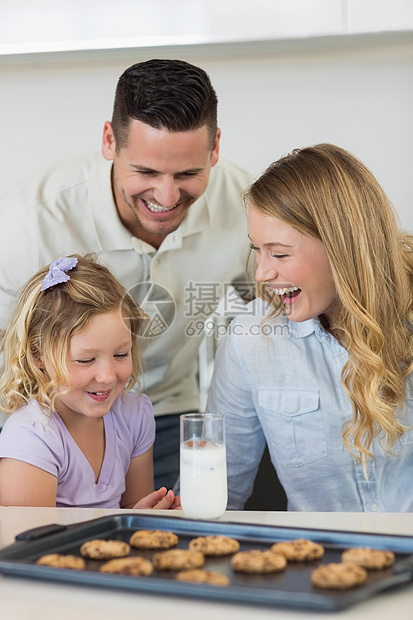在柜台有牛奶和饼干的家庭图片