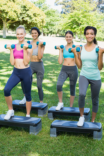 运动妇女在公园里做有节育的职级运动图片