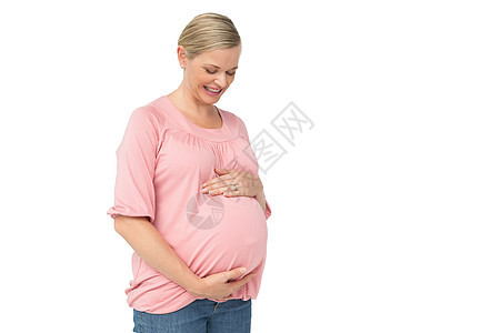 孕妇低头看着她的腰部图片