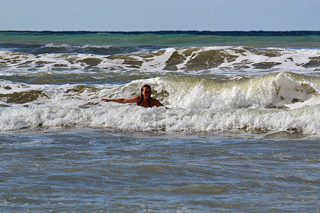 女人在海中对抗大浪波浪飞溅风暴女孩沐浴者背景图片