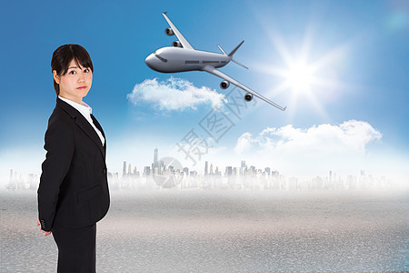 严肃的女商务人士形象综合图象职业人士飞行旅游女士旅行飞机摩天大楼数字沙漠图片