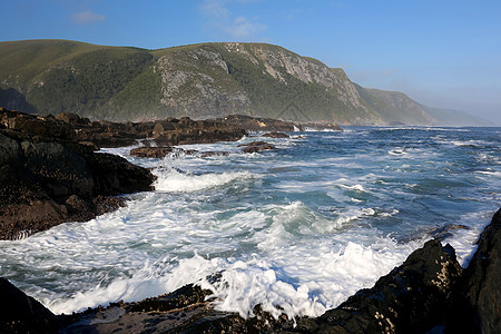 南非的沿海景点荒野蓝色海岸悬崖海洋气候阳光海浪旅行石头背景图片