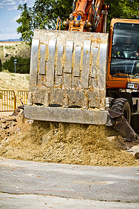 橙色重型建筑挖土机搬运工运动土壤活动蓝色地面车辆拖拉机沙坑力量图片