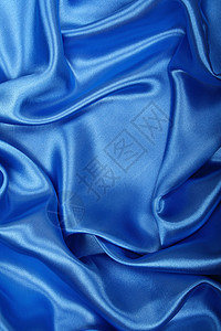 平滑优雅的蓝色丝绸作为背景布料折痕海浪银色投标纺织品天蓝色材料曲线织物图片