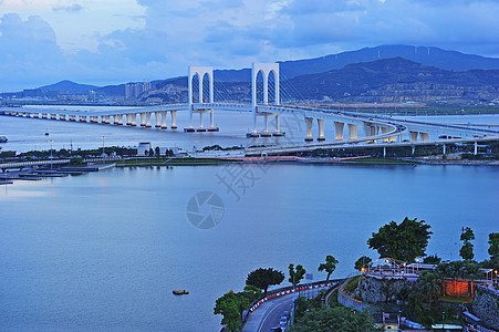 澳门赛万桥建筑学两极灯柱建筑天空中心灯光货车地标圆形背景图片