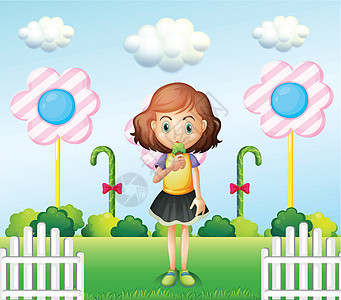 一个女孩在围栏附近吃冰淇淋 带着巨型糖果图片