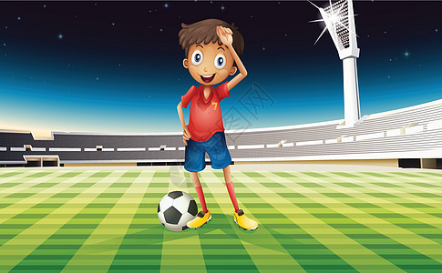 一个足球球男孩 站在足球场的足球场上图片