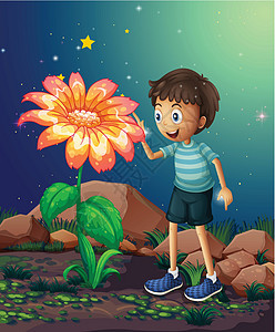 一个年轻男孩 在巨大的花朵旁边图片