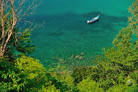 一条传统的长尾船漂浮在完全晶晶的 清晰的微粒中地标热带旅游旅行情调海景天堂海岸水晶海滩图片