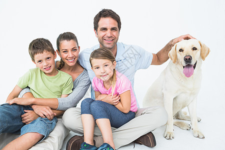 带着宠物拉布拉多人装扮的可爱家庭 并一起在镜头中微笑图片