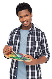 一位年轻男性画家带着调色板的肖像天赋衬衫刷子爱好艺术男人黑色绘画画笔创造力图片