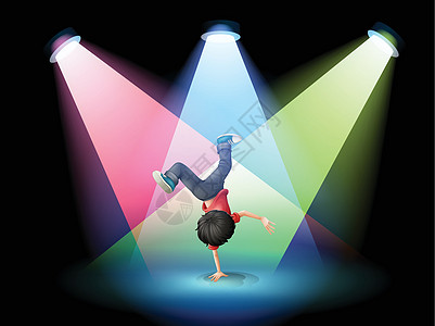 一个男孩在舞台上用聚光灯跳起舞图片