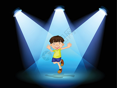 一个可爱的小男孩在舞台上跳舞图片