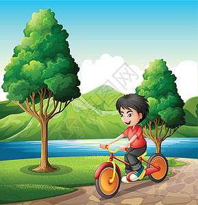 一个男孩在河岸骑自行车图片