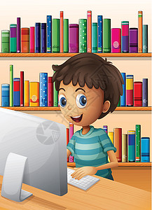 一名男孩在图书馆内使用电脑图片