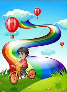 在山顶骑着彩虹的男孩图片