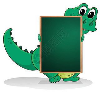 一只小鳄鱼在空绿板的后面图片