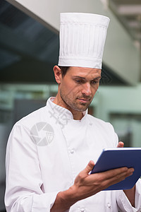 使用平板电脑主厨 pc专注男性大楼酒店药片餐厅厨房餐饮触摸屏白人图片