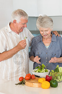 微笑的老年夫妇准备沙拉男人夫妻女士木板退休快乐女性切菜板家庭住所图片