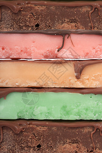 不同颜色的抛牌条绿色橙子甜点薄荷糖果粉色巧克力酒吧背景图片