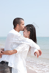 非洲男人和亚洲女人在海滩上的爱人喜悦蓝色男性女性海洋小猪乐趣感情假期女士图片