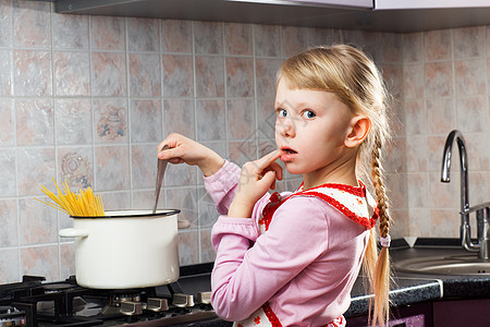 在厨房做饭的 不知所措的女孩图片