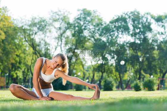 在公园里做瑜伽的女人有氧运动姿势微笑运动身体树木娱乐饮食成人活力图片