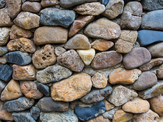 岩墙灰色围墙纹理棕色河石挡土墙韧性石头圆圈石墙图片