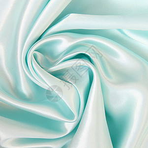 平滑优雅的蓝色丝绸作为背景折痕曲线投标纺织品织物银色海浪布料材料图片