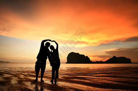 浪漫情侣在海滩日落时握手家庭阳光海岸男性蜜月天空假期女孩夫妻男人图片