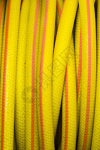 黄色和橙色水管灌溉管道花园塑料软管技术橡皮园艺植物管子图片