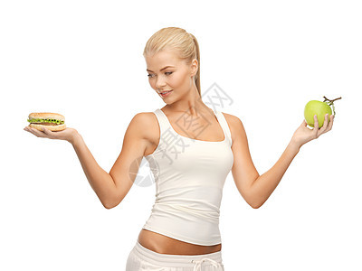 配有苹果和汉堡包的妇女控制减肥生物饮食碳水福利数字维生素运动女孩图片