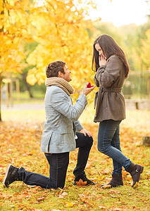 男人在秋天公园向女人求婚新娘微笑婚礼夫妻戒指感情家庭订婚公园季节图片