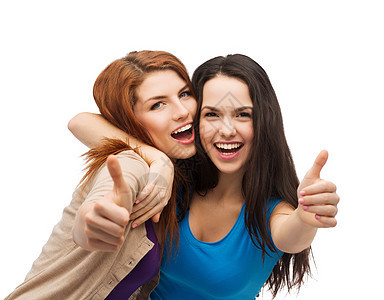 两个微笑的女孩 伸出大拇指女性手势友谊闺蜜学生青少年衣服微笑快乐成就图片
