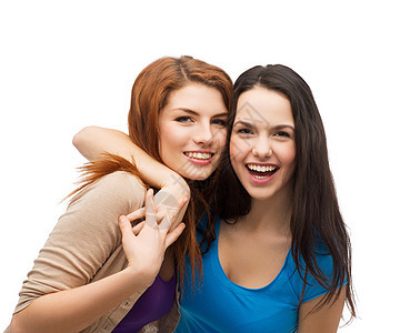 两个笑着的女孩拥抱抱抱白色女性成年人闺蜜衣服学生快乐微笑友谊乐趣图片
