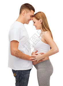 幸福的年轻家庭预产期子女妻子男生父母母性孩子拥抱男性母亲丈夫婴儿图片