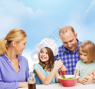 有两个孩子在家吃饭的幸福家庭午餐胡椒沙拉教学蓝色母亲厨师食物厨房女士图片