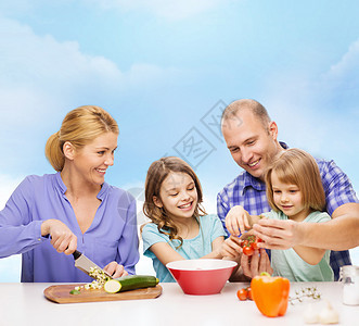 有两个孩子在家做晚饭的幸福家庭午餐厨房男人桌子帮助母亲烹饪微笑父亲教学图片