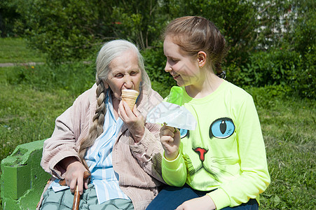 外婆和她孙女在一起金发幸福奶油锥体家庭童年微笑食物女性甜点图片