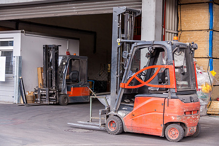 停在仓库的小型橙色叉车货物托盘袖珍工厂运输升降机货运卡车工业机械图片