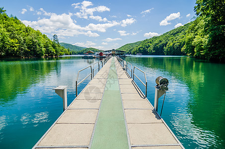 大型大烟雾山的fontana湖渔船和斜坡旅游阳光森林全景支撑天空叶子反射游船蓝色图片