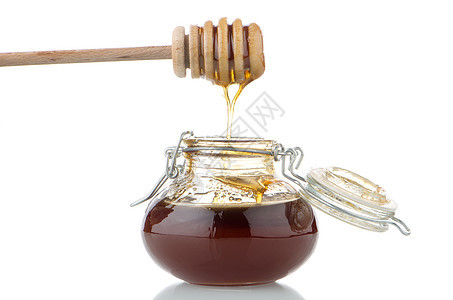 配有木制干洗机的加热蜂蜜罐蜂蜜产品营养治愈液体甜点金子木头工具花蜜图片
