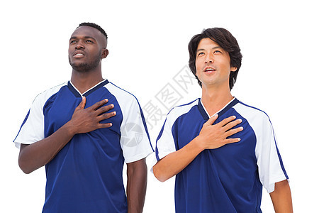蓝蓝色足球运动员 用手抓心图片