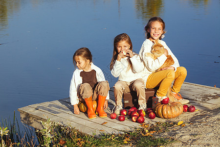 秋天孩子们在湖边玩友谊闲暇旅行姐妹南瓜团体靴子乡村朋友们农村图片